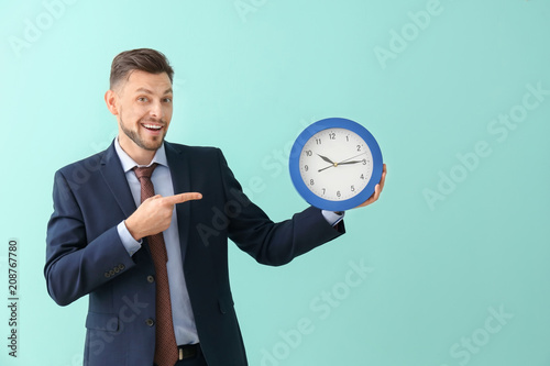 Businessman with clock on c...