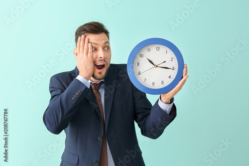 Businessman with clock on c...