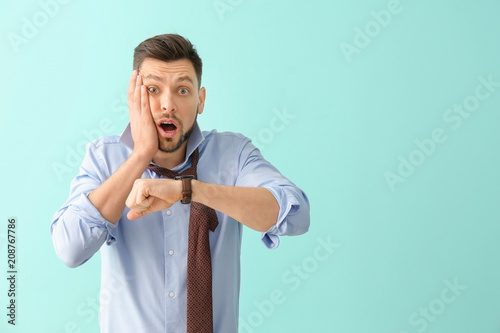 Man with wristwatch on colo...