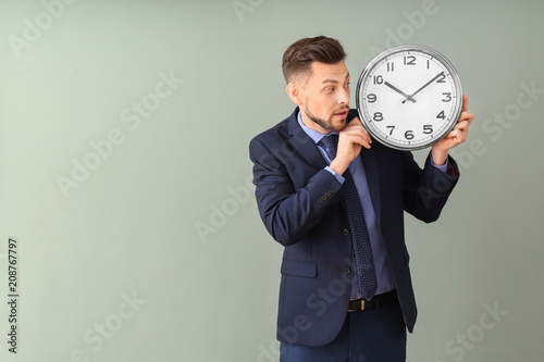 Businessman with clock on c...