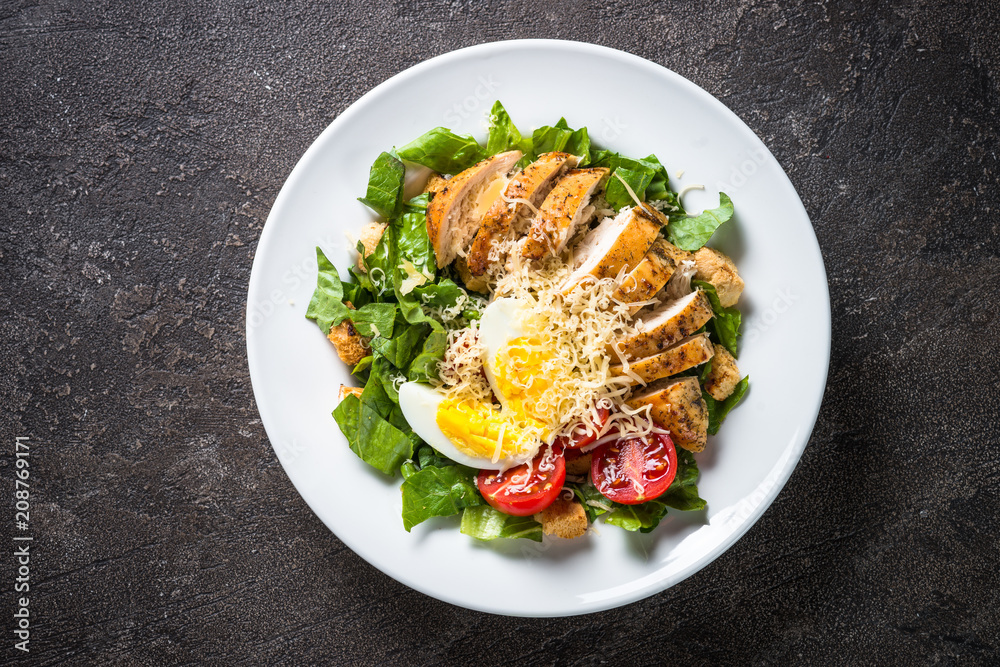 Caesar salad with chicken breast and tomatoes. Caesar salad with chicken breast and tomatoes.