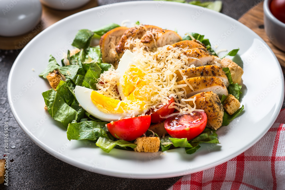 Caesar salad with chicken breast and tomatoes. Caesar salad with chicken breast and tomatoes.
