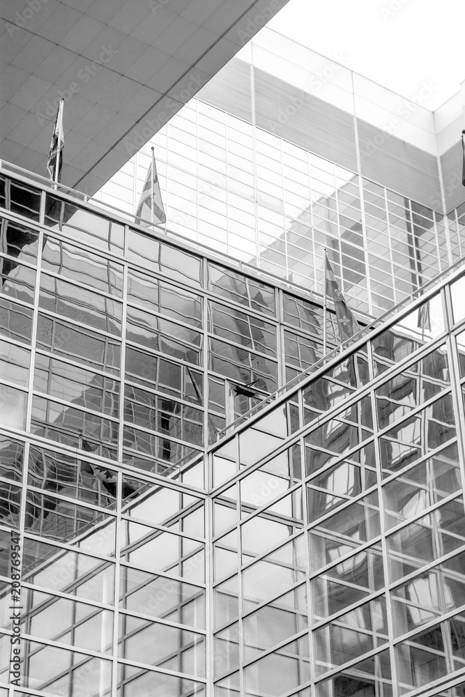 Reflections in the windows of tall buildings with flags Reflections in the windows of tall buildings with flags
