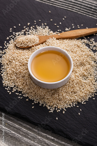 fresh sesame seeds on a rustic background © Narsil