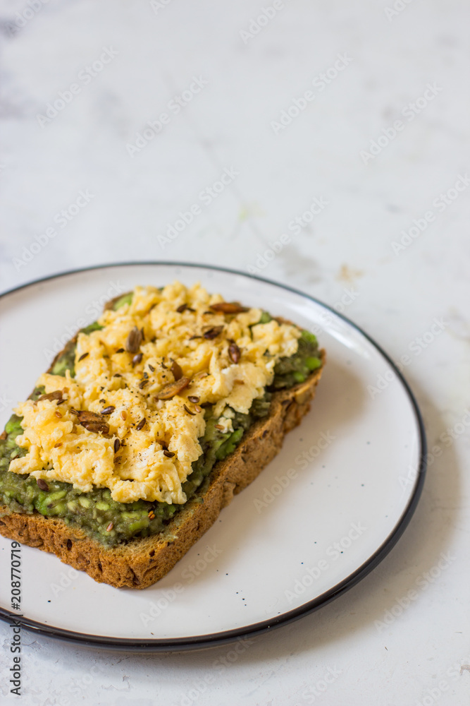 Scrambled eggs on whole wheat bread with avocado Scrambled eggs on whole wheat bread with avocado