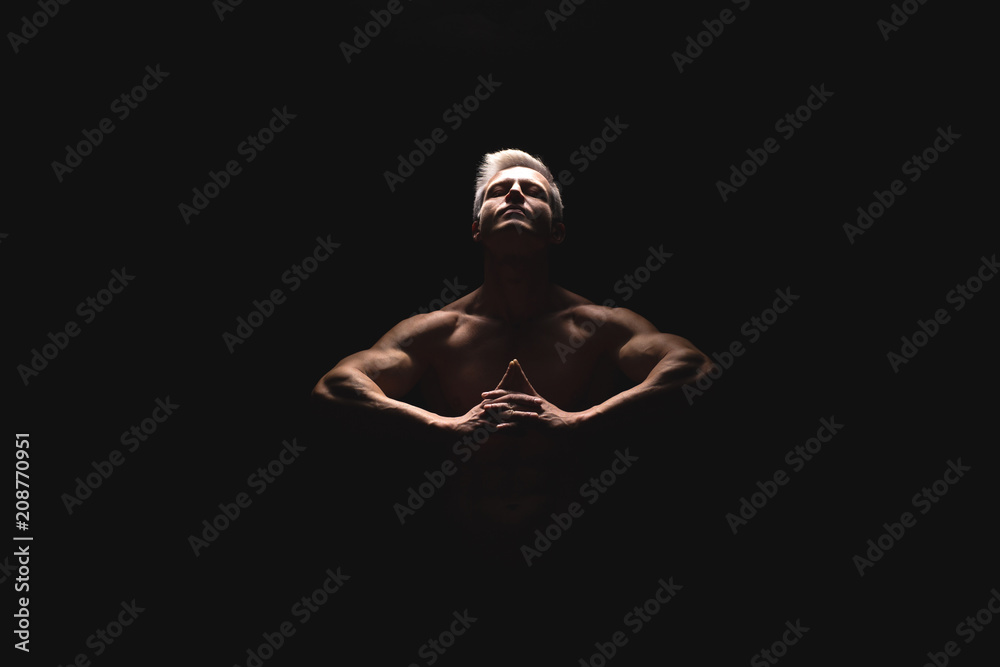 Handsome power athletic man in dramatic light. Strong bodybuilder with perfect shoulders, biceps, triceps, back, delta and chest. Strength and motivation Handsome power athletic man in dramatic light. Strong bodybuilder with perfect shoulders, biceps, triceps, back, delta and chest. Strength and motivation