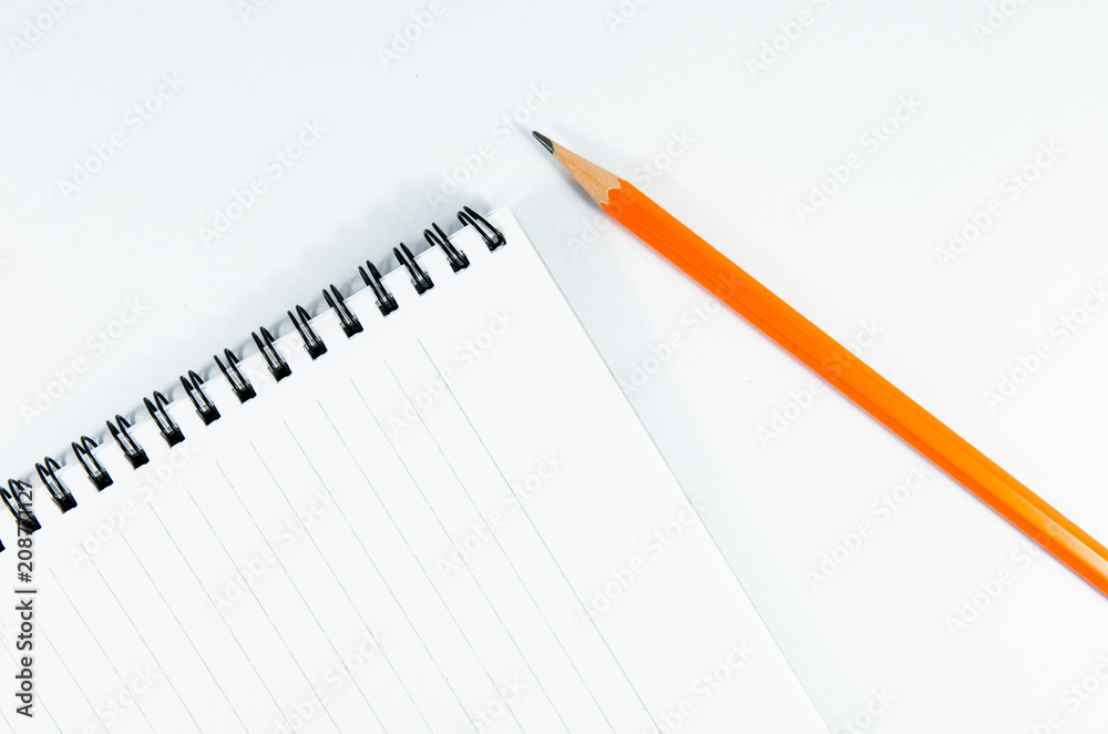 blank notebook and pencil on oblique position blank notebook and pencil on oblique position