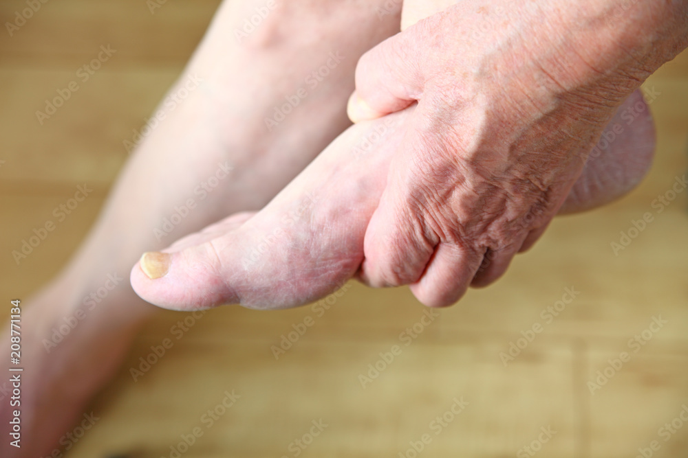 Man holding his foot Man holding his foot