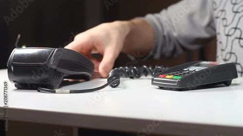 two people carry out a money transaction with the help of a terminal