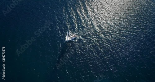 Yacht sailing at windy day. Freedom of Yachting at opened sea / ocean. Aerial, drone video.