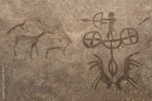 An image of a hunting scene of an ancient man on a cave wall. ancient history, archeology.