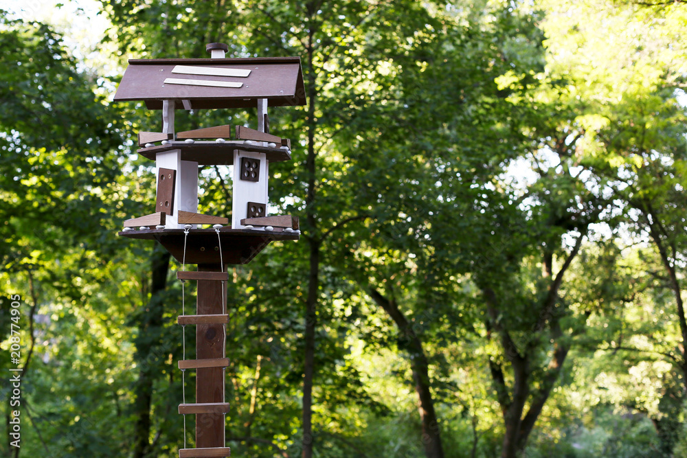 An unusual birdhouse in the forest. An unusual birdhouse in the forest.