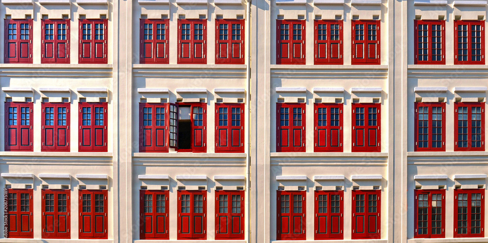 white building and red windows in classic colonial architecture buildings in  singapore china town