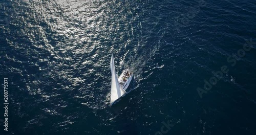 Yacht sailing at windy day. Freedom of Yachting at opened sea / ocean. Aerial, drone video.