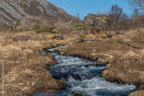 Creek at Rorvikstranda beach and Gimsoystraumen fjord near Henningsvaer at Lofoten Islands / Norway photo