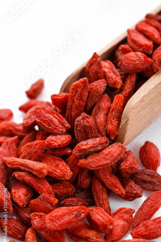dried goji berries on a white acrylic background