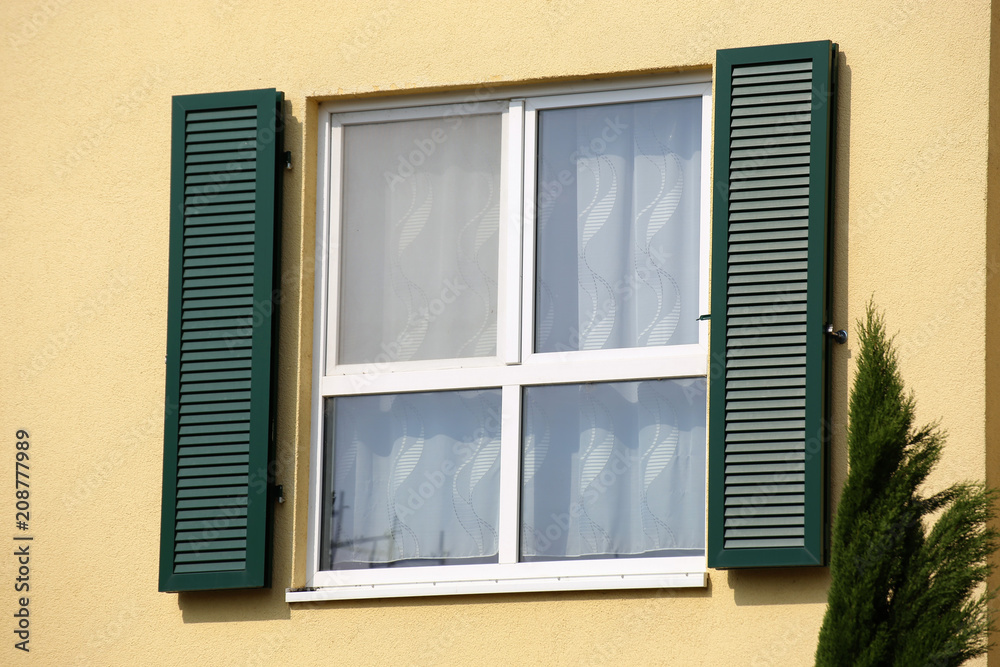 Window with wooden shutter, exterior shot
