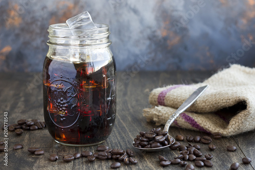 Iced Coffee in a Jar with a Spoon Full of Coffee Beans