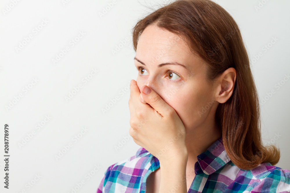 young woman covered her mouth with her hand young woman covered her mouth with her hand