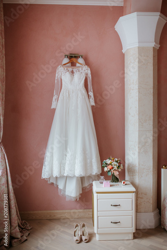 top view of wedding bouquet and dress on the wall