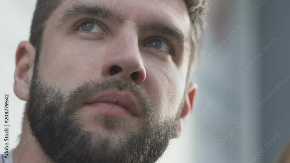 Handsome man looking at scoreboard, last decisive minutes in sport competition Handsome man looking at scoreboard, last decisive minutes in sport competition