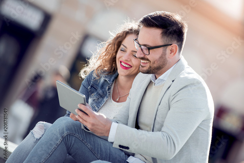 Couple with tablet on the street