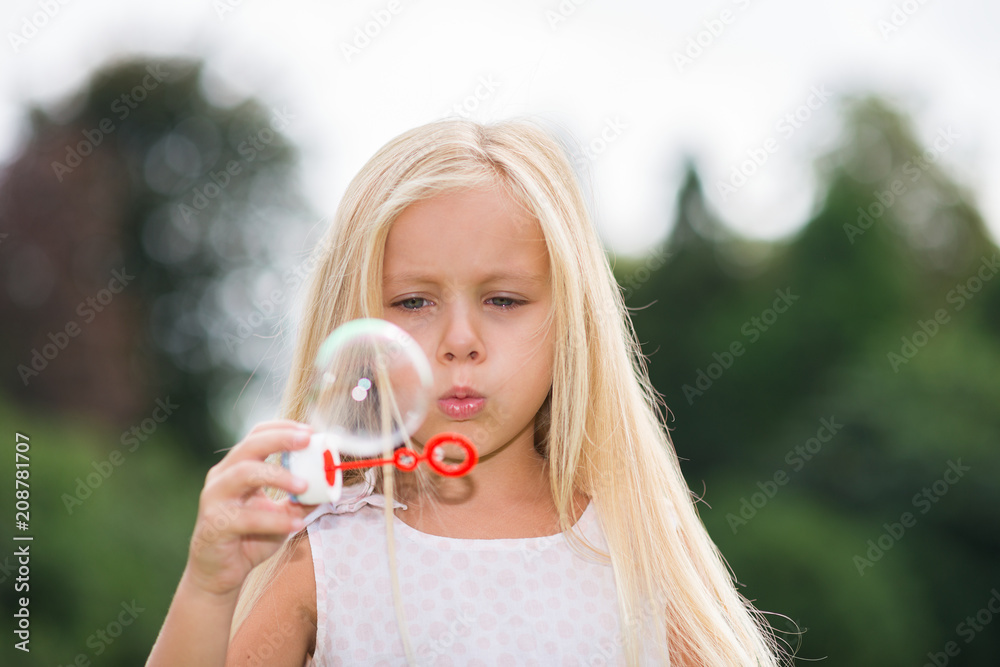 Child making soap bubbles