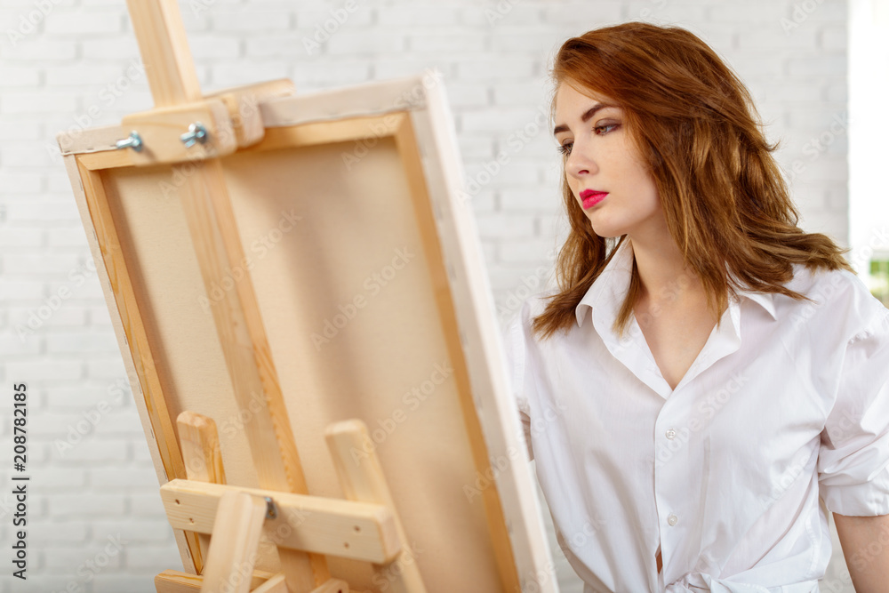 Beautiful young woman painter at work Beautiful young woman painter at work