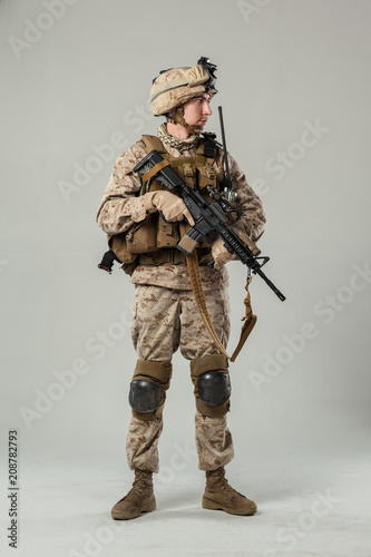 Soldier in camouflage holding rifle
