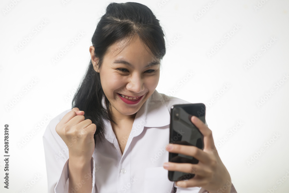 Delightful, happy emotional woman, closing her face with pleasure feeling excited while using smartphone. Delightful, happy emotional woman, closing her face with pleasure feeling excited while using smartphone.