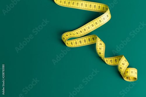 measure tape on a green background