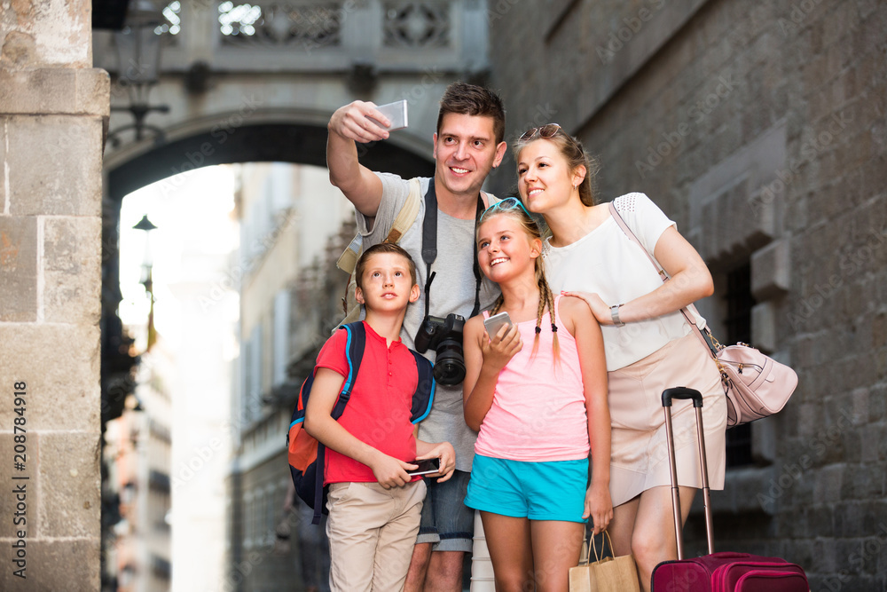 Husband with wife and children are traveling together, taking selfie