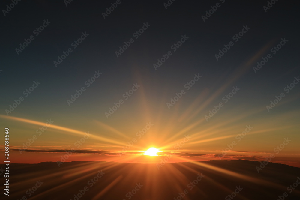 Fantastic view of sunrise over the clouds seen from airplane window 