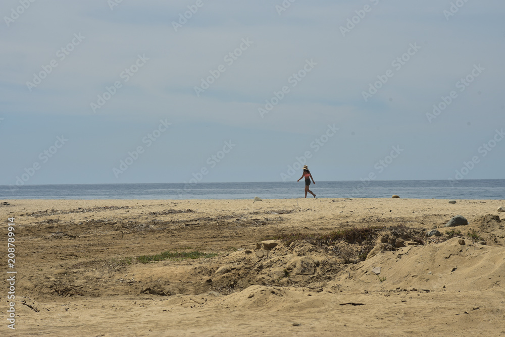 young solitary walker on seashore Baja, Mexico