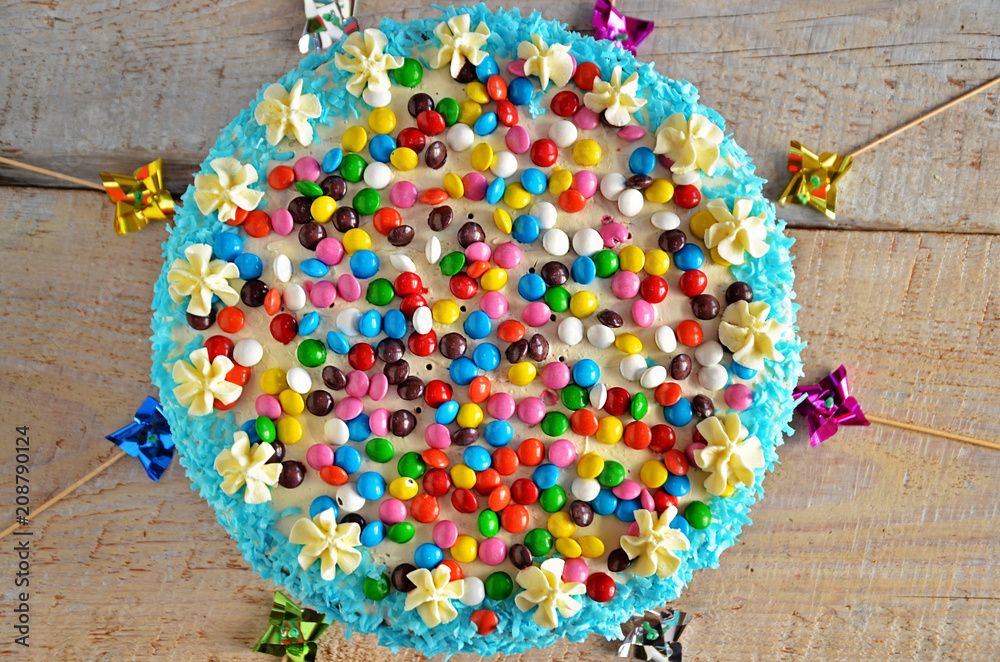 Colorful cake on a kinder party on a wooden background