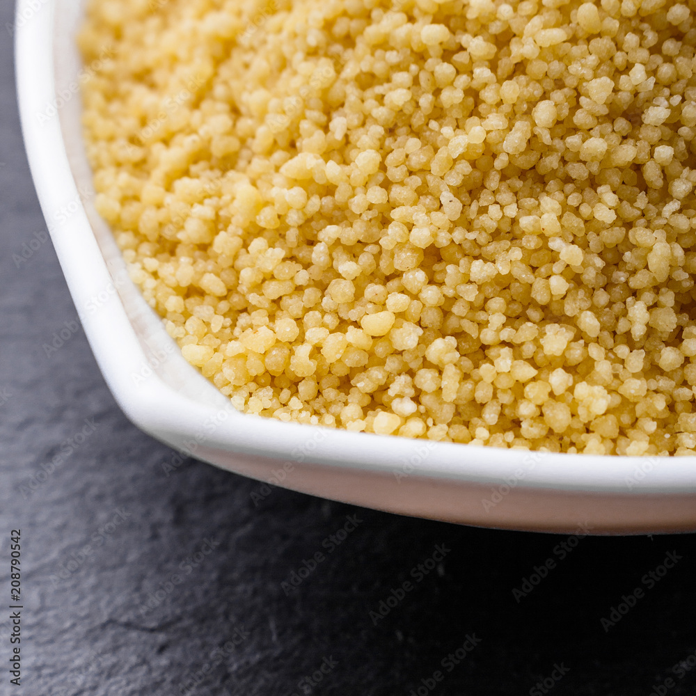 fresh couscous on a dark stone background fresh couscous on a dark stone background