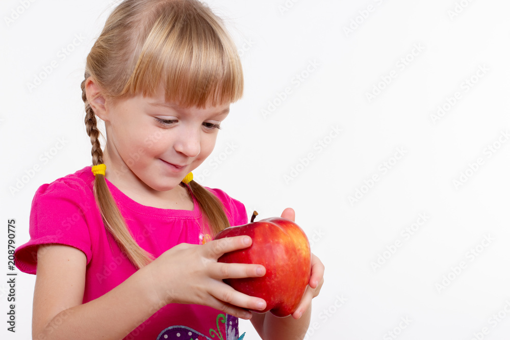 little blond girl with red delicious apple on white background little blond girl with red delicious apple on white background