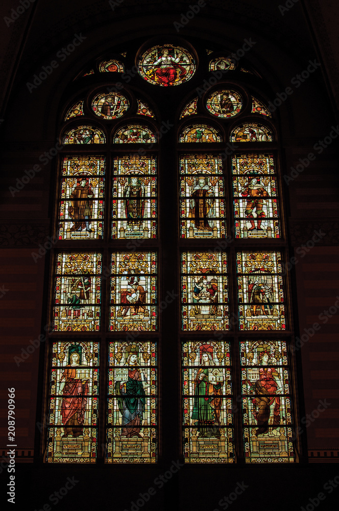 Colorful stained glass window at the Rijksmuseum (National Museum) in Amsterdam. Famous for its huge cultural activity, graceful canals and bridges. Northern Netherlands.