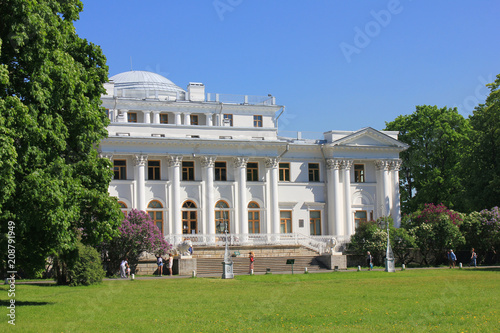 Yelagin Palace Historical Villa Facade and Green Park Lawn in Front in Saint Petersburg, Russia. Former Royal Summer Palace, White Building Exterior Architecture on Summer Day with Empty Grass View.