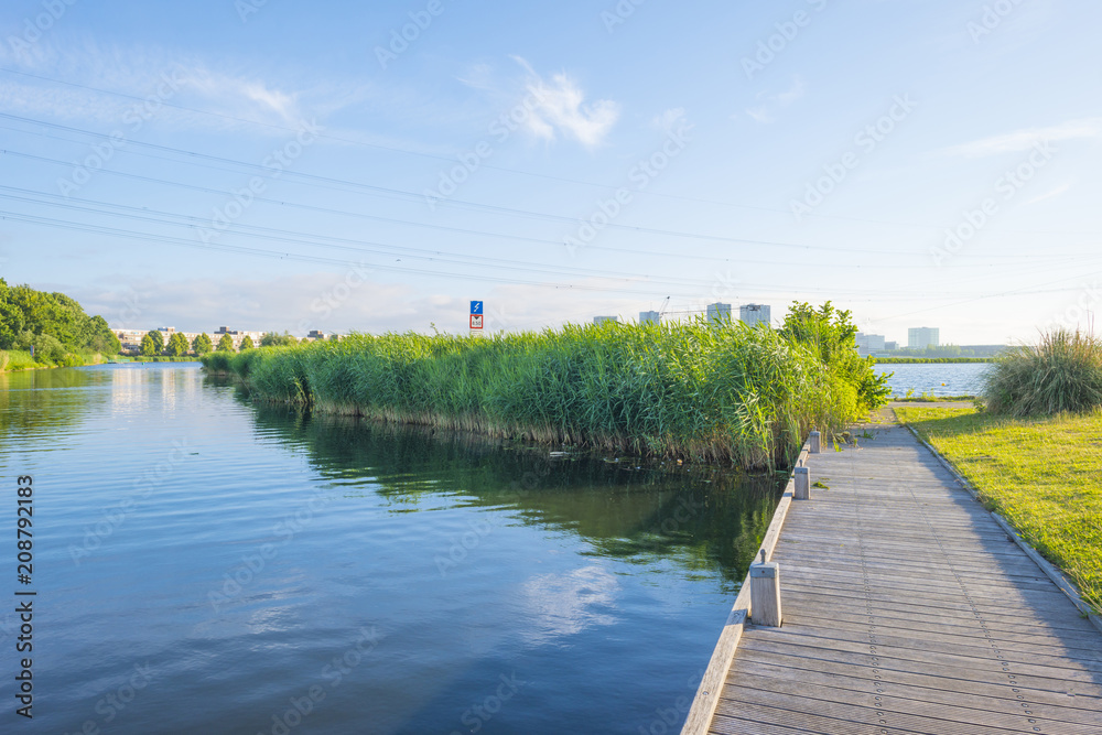 Skyline of a city along the shore of a lake at sunrise in spring Skyline of a city along the shore of a lake at sunrise in spring
