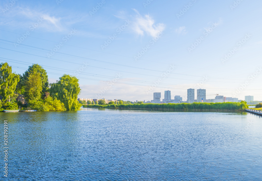 Skyline of a city along the shore of a lake at sunrise in spring