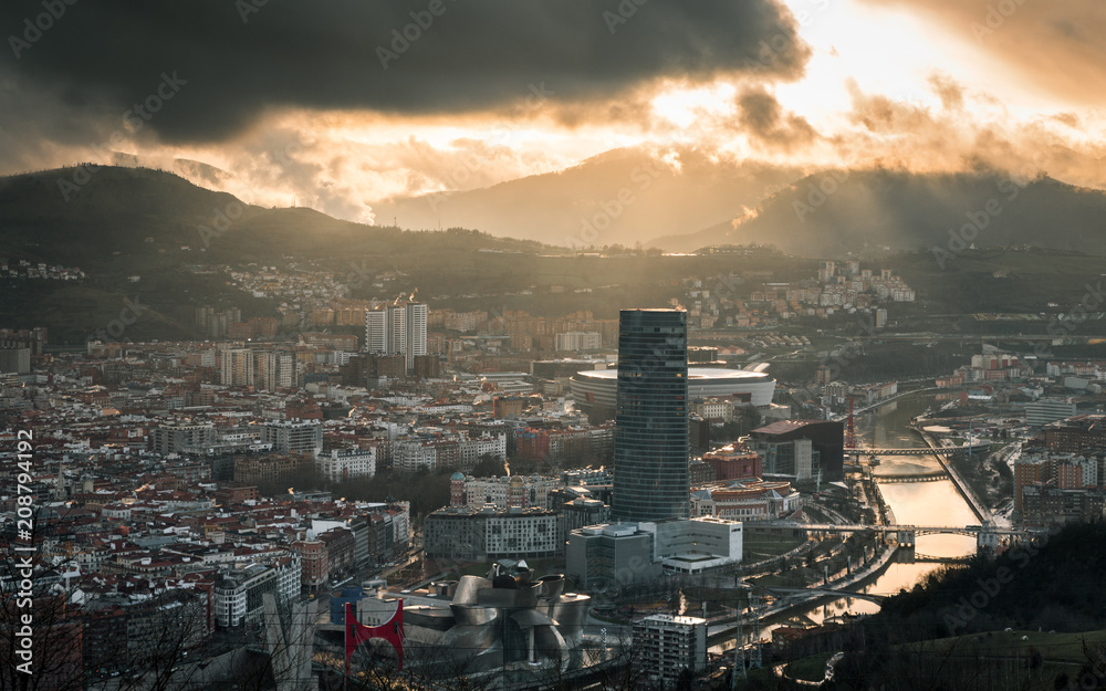 Modern skyscraper and old town under cloudy sky Modern skyscraper and old town under cloudy sky