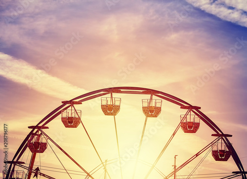 Vintage toned picture of a Ferris wheel at sunset.