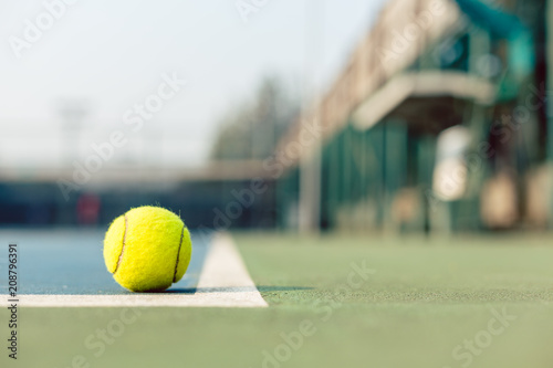 Obraz na plátně High-angle close-up of a fluorescent yellow tennis ball in the corner at the bas