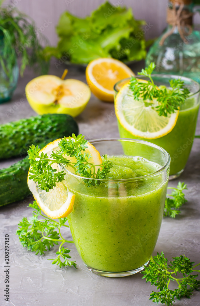 Refreshing smoothies from cucumber, green apple, fresh herbs and lemon juice in transparent glasses on the table. The concept of a healthy diet. Vegetarian menu Refreshing smoothies from cucumber, green apple, fresh herbs and lemon juice in transparent glasses on the table. The concept of a healthy diet. Vegetarian menu