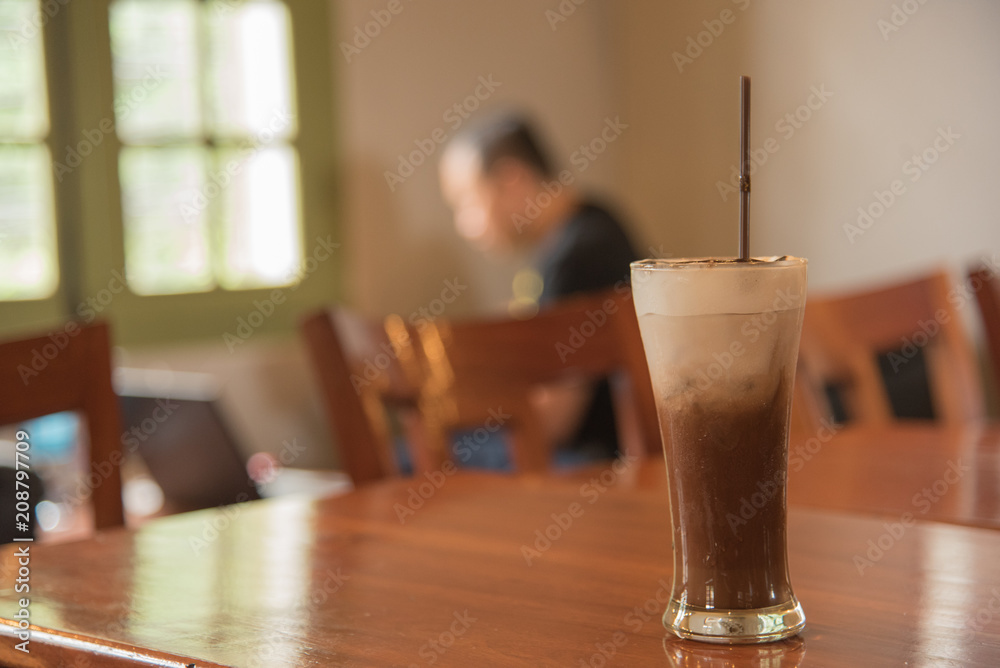 mocha coffee on table in coffee shop with man on background mocha coffee on table in coffee shop with man on background