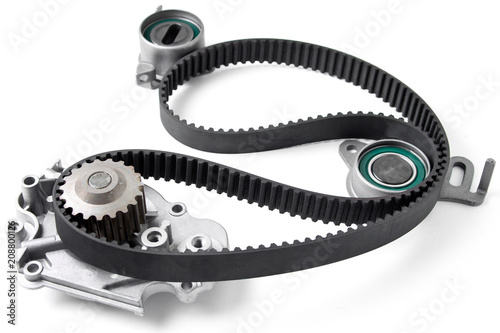 Spare parts for the ca r. Kit of timing belt with rollers on a light background.