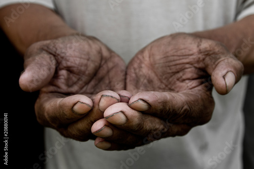 The poor old man's hands beg you for help. The concept of hunger or poverty. Selective focus. Poverty in retirement. Alms photo