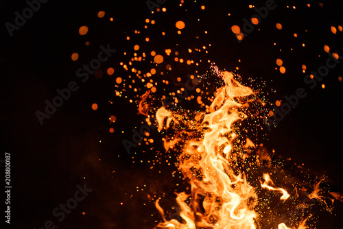 fire flames with sparks on a black background © Pavel