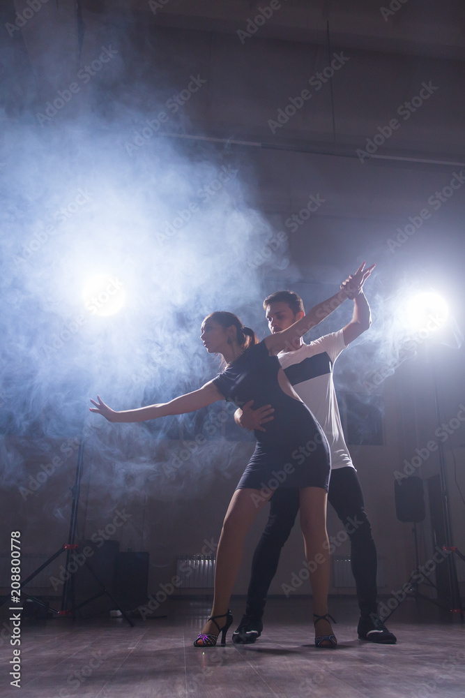 Active happy adults dancing bachata together in dance class